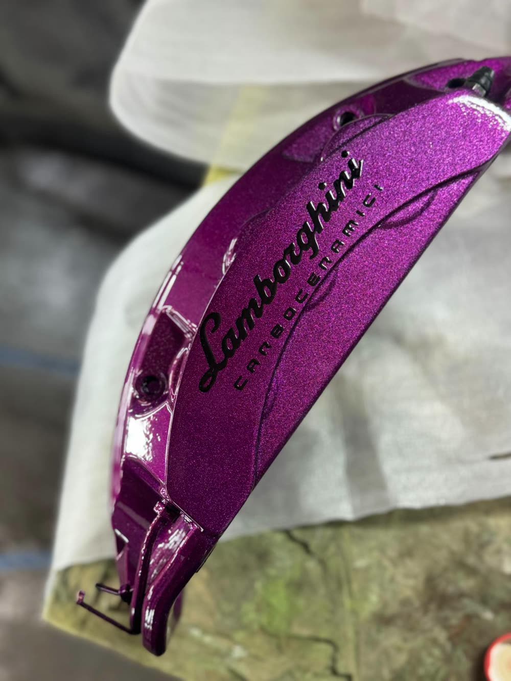 Lamborghini carbon-ceramic brake caliper refinished in metallic purple